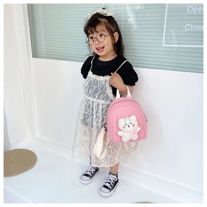Pink toddler backpack featuring a cute white plush bear with heart bow detail