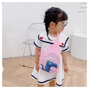 Pink dinosaur egg crossbody bag shown on child model for size and style reference