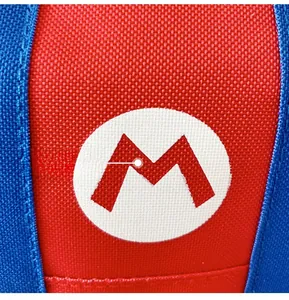Detail of red and blue contrast fabric on a kids backpack featuring a white M logo