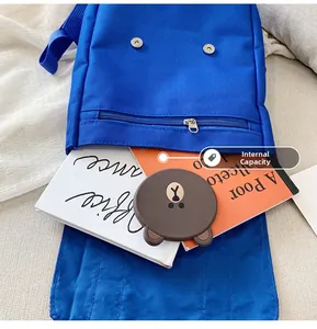 Detail view of the spacious inner compartment of this blue canvas kids backpack