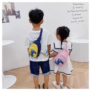 Detail showing cartoon dinosaur crossbody bags in navy and pink for kids with adjustable straps
