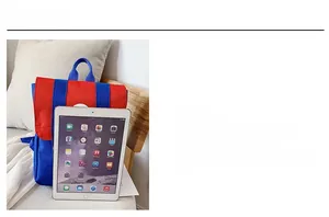Detailed size comparison of a red and blue kids backpack next to an iPad for scale
