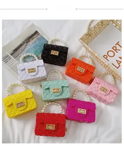 Overhead view of colorful mini jelly handbags with pearl handles and woven texture
