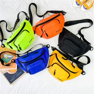 Collection of colorful nylon kids chest bags in neon green, orange, blue, and yellow