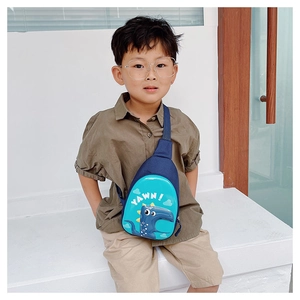 Close-up of blue dinosaur egg-shaped kids chest bag with YAWN print and adjustable strap