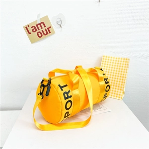 Detail view of the yellow cylinder sports bag with SPORT print and black zipper