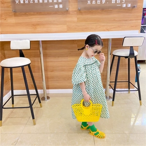 Detail of yellow hollowed-out plastic basket bag and sandals for beach outfits
