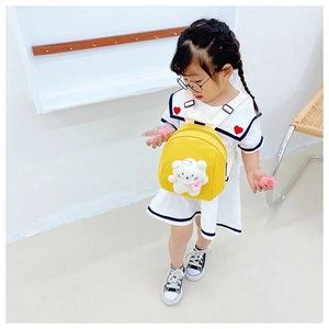 Detail of yellow toddler backpack featuring a 3D plush bear on durable canvas fabric