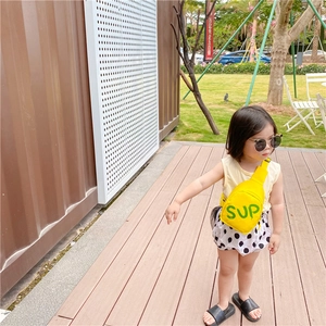 Close-up of yellow children's crossbody bag featuring green SUP print and adjustable strap