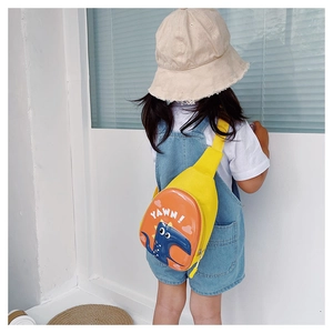 Detail of yellow toddler dinosaur crossbody bag with adjustable strap worn by child