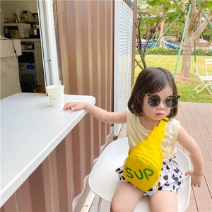 Detail of yellow canvas kids chest bag with green SUP letter print and black strap