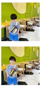 Close-up of kids colorful crossbody bag with yellow body and PLAY! print lettering