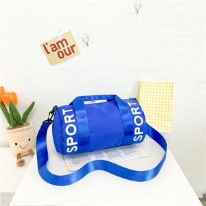 Close-up of blue nylon cylinder sports bag featuring a large white SPORT logo print