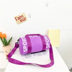 Close-up of a purple cylinder kids sports bag with white SPORT text and adjustable strap