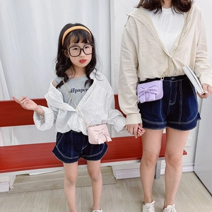 Pink and purple girls' mini bow crossbody bags with gold chain straps shown by models