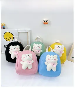 Detail view of colorful mini backpacks featuring 3D plush bear charms in five vibrant colors