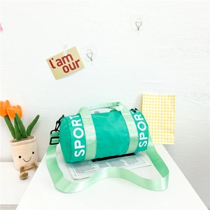 Detail of mint green cylindrical kids sports bag with SPORT print and adjustable strap