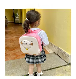 Toddler girl wearing a pink egg-shell backpack with a cute 3D cartoon sheep design