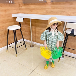 Detailed summer outfit with green checkered girl dress and colorful hollow plastic bags
