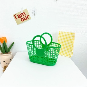 Detail of green hollow mesh plastic beach bag with circular handles for kids and summer outings