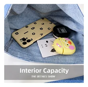 Internal capacity of the blue denim kids bag showing space for phone and accessories