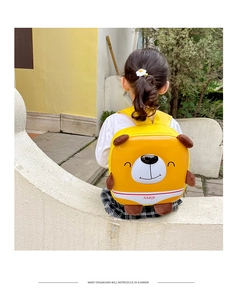 Detail of cute yellow bear hard shell backpack for kids with 3D ears and NMQI logo