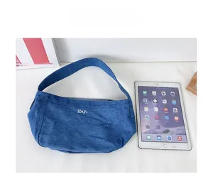 Blue denim canvas tote bag for kids shown next to an iPad for size comparison