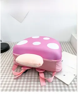 Detail of pink mushroom toddler backpack featuring soft plush texture and EVA shell