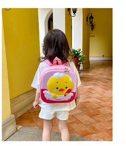 Pink eggshell toddler backpack featuring 3D yellow duck design on a child model back