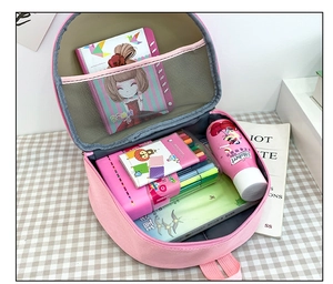Pink cartoon mushroom backpack interior with a zipper compartment and mesh storage pocket