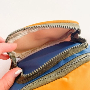 Kids chest bag with blue and yellow color block design and nylon zipper compartments