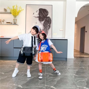 Kids sports cylinder crossbody bags in black and orange colors with SPORT strap detail