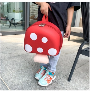 Toddler mushroom backpack with a red EVA hard shell and plush handle detail