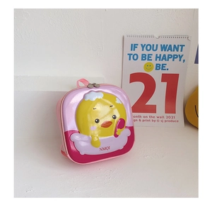 Detail of pink hard shell kids backpack featuring a cute yellow duck cartoon and letters