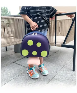Detailed view of a purple mushroom-shaped toddler backpack with green polka dots for kids