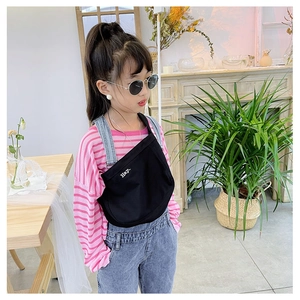 Detail of black canvas kids crossbody bag with white Hey letter embroidery and strap