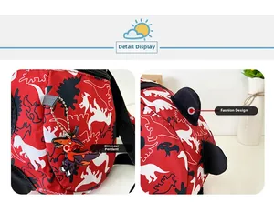 Detail of red toddler backpack featuring dinosaur silhouette patterns and rubber charm