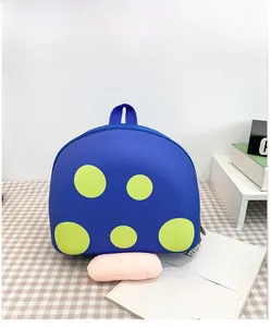 Detail view of a cute blue mushroom kindergarten backpack with yellow polka dots