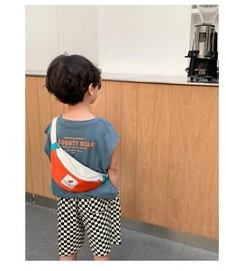 Vue arrière d'un enfant portant un sac bandoulière en toile avec détail de feuille