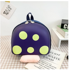 Detailed view of the purple mushroom shell backpack with yellow dots and dual zipper closure