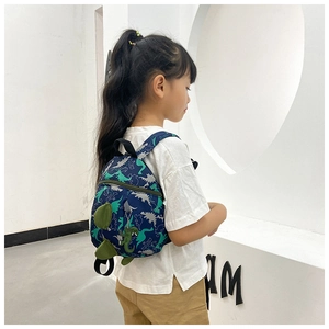 Detail of cute dinosaur pattern backpack for boys with 3D green fin decorations