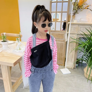 Kids pink striped long sleeve tee with denim overalls and black canvas crossbody bag
