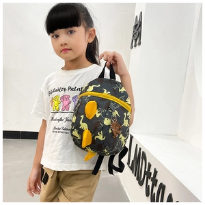 Detail of grey toddler dinosaur backpack with yellow 3D horns and fun cartoon patterns