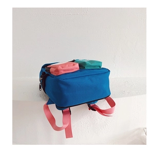Detail view of colorful preschool backpack with blue body and pink contrast pockets