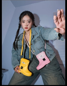 Detail of pink and yellow creative rain boot mini crossbody bags with letter patch