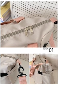Detailed view of grey travel bag featuring sturdy metal zippers and side mesh pockets
