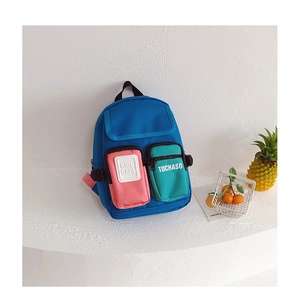 Detail of color-block canvas kids backpack with blue, pink and green zipper pockets