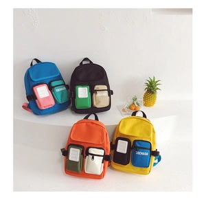 Mini canvas backpacks for kids in blue, black, orange, and yellow with dual front pockets