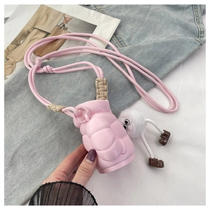 Detailed view of pink puffer crossbody bag with plush monster charm and rope strap