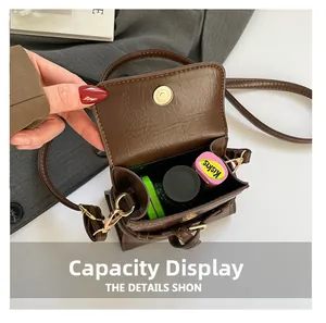 Internal view showing brown retro crossbody bag capacity with lipstick and magnetic closure